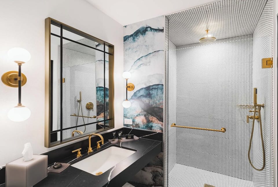 Unwind under a rainfall shower surrounded by designer tile.
