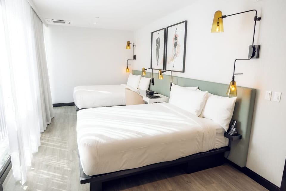 Stretch out in crisp linens beneath warm, modern bedside lighting.