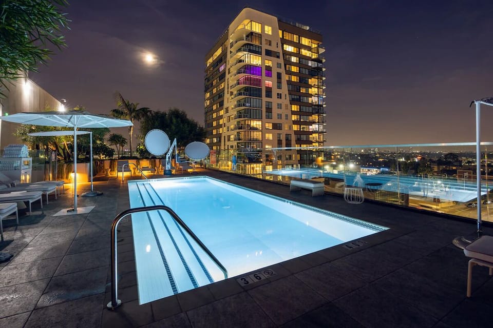 Swim after dark with sparkling city views all around.