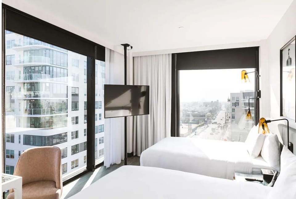 Settle into a sunlit corner room with sweeping city views.