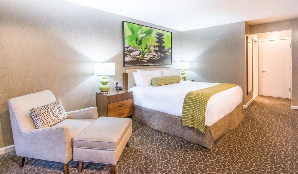 Stretch out in a serene king room with cozy lounge chair.