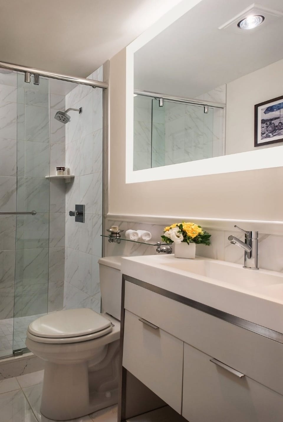 Refresh under a glass shower, then enjoy a spotless vanity.