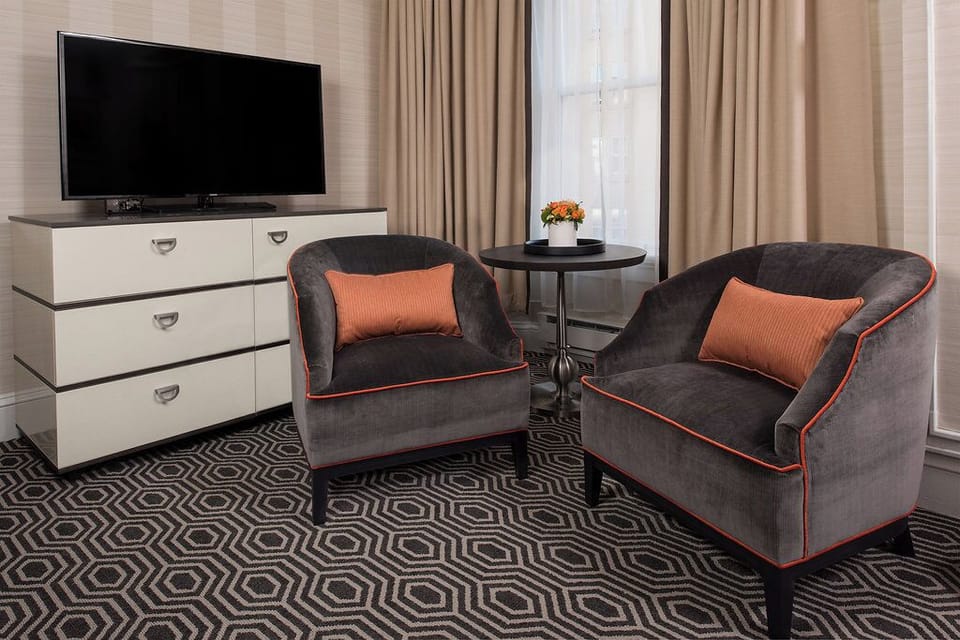 Relax in cozy lounge chairs beside soft daylight and warm accents.