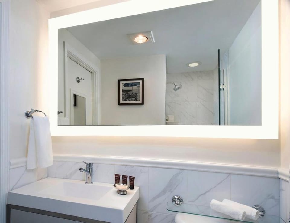 Start your day at a glowing mirror with spa-clean finishes.