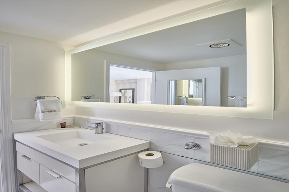 Refresh effortlessly at a sleek vanity with bright mirror lighting.