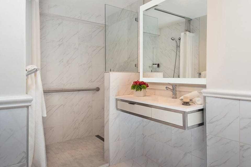 Move comfortably in a sleek bath with spacious walk-in shower.