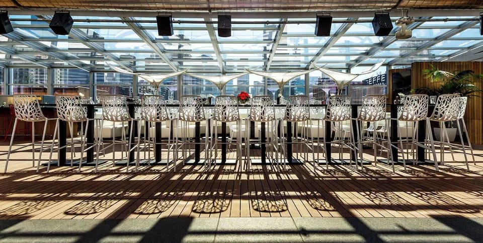 Pull up a stool and enjoy open, sunlit rooftop service.