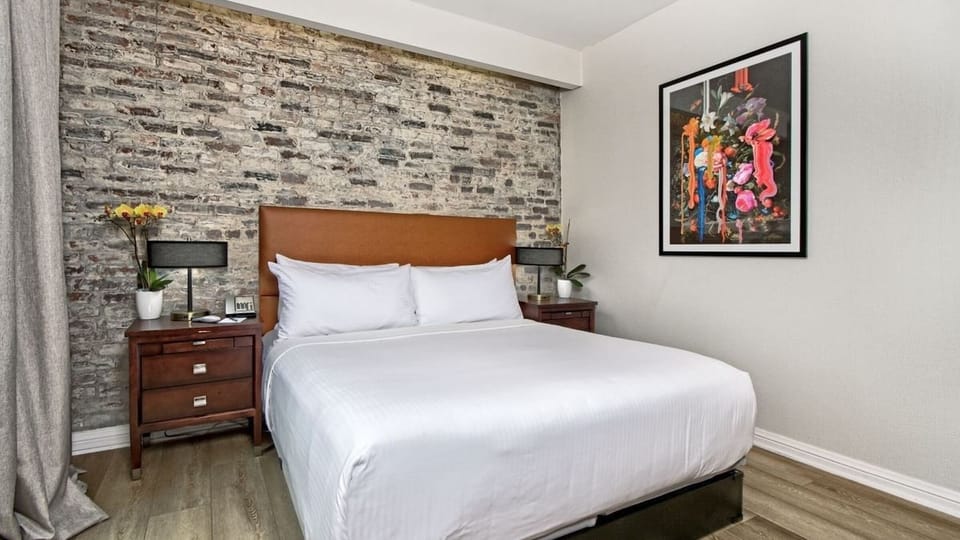 Unwind in a stylish brick-accent room made for deep sleep.