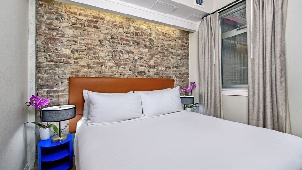 Drift off in quiet comfort with plush pillows and soft lighting.