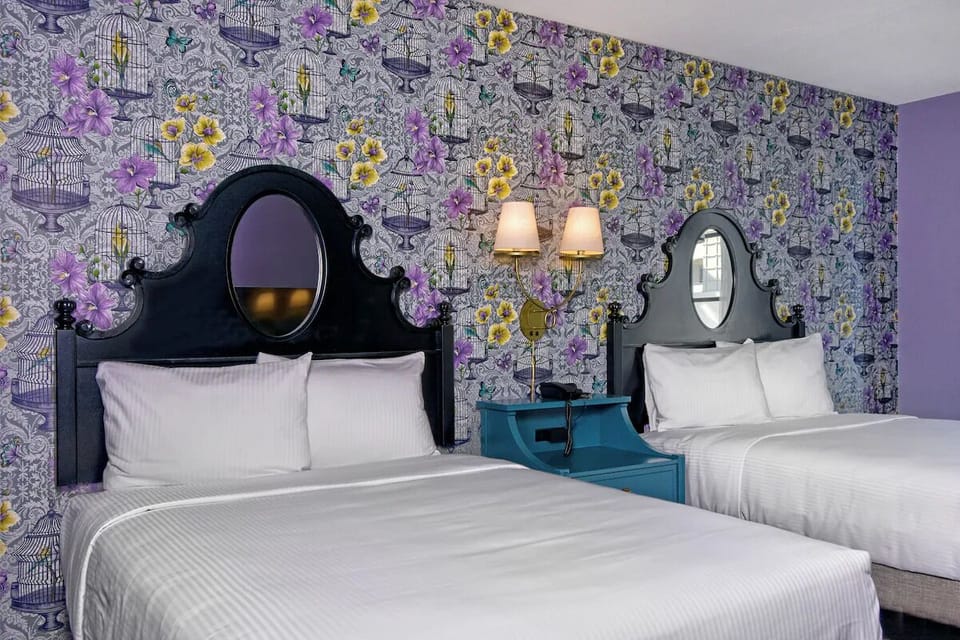 Escape into a whimsical, design-forward room with plush beds.