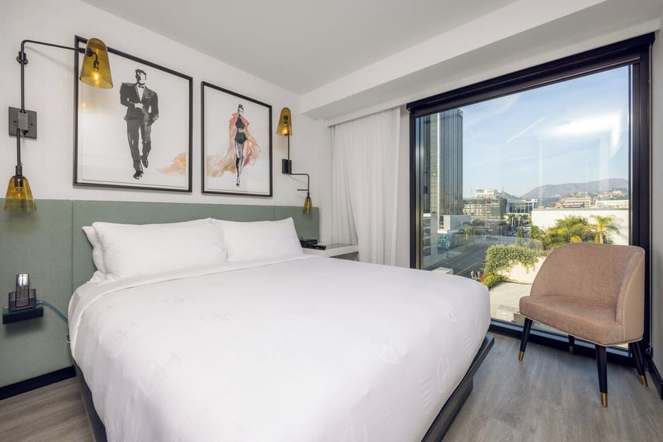 Breathe in morning light beside wide windows and soft pillows.