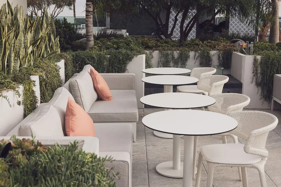 Settle into breezy rooftop seating surrounded by lush planters.