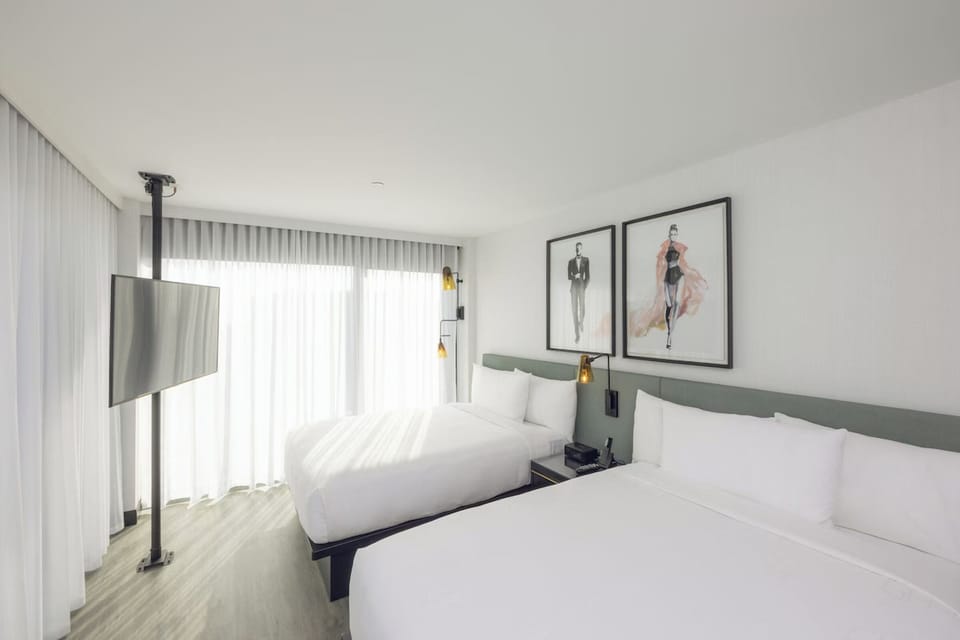 Relax in a sunlit double-queen room made for easy stays.