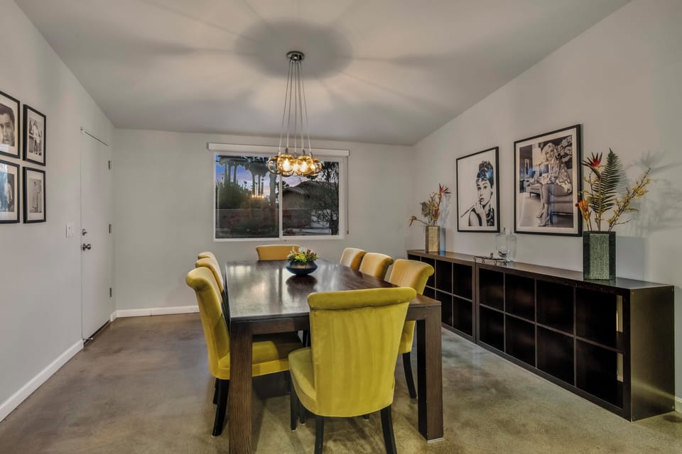 Elegant dining room with statement lighting and seating for eight