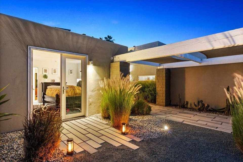 Evening courtyard entry with ambient desert landscaping