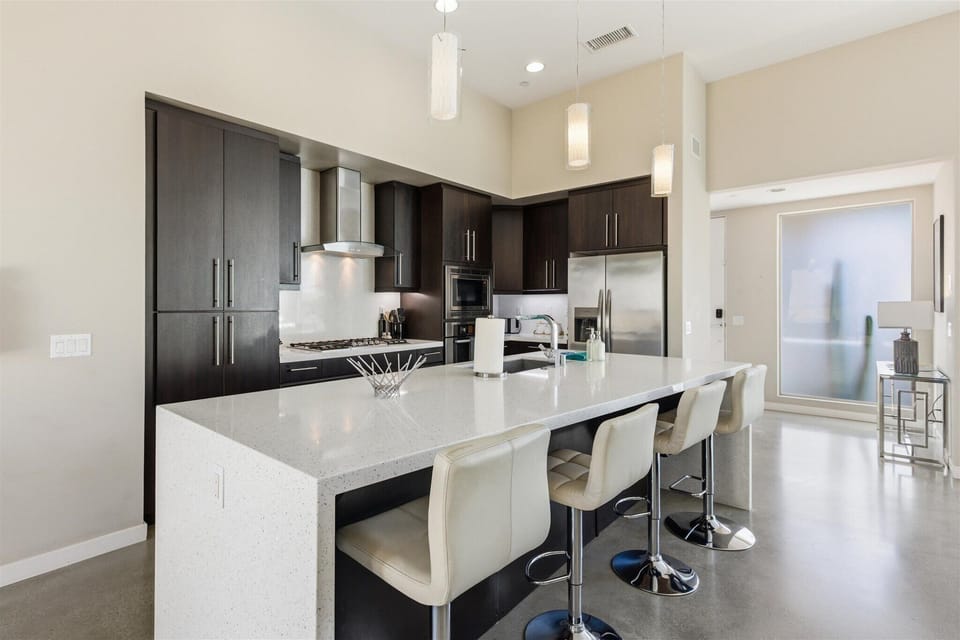 Chef's kitchen with quartz island and bar seating