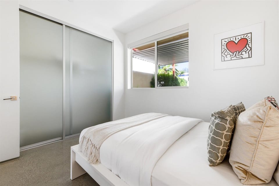 Guest bedroom with frosted closet doors and peaceful garden light