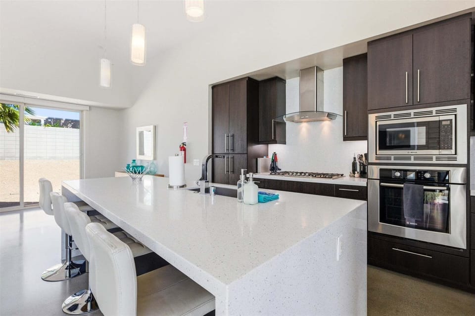 Gourmet kitchen with large quartz island and bar seating