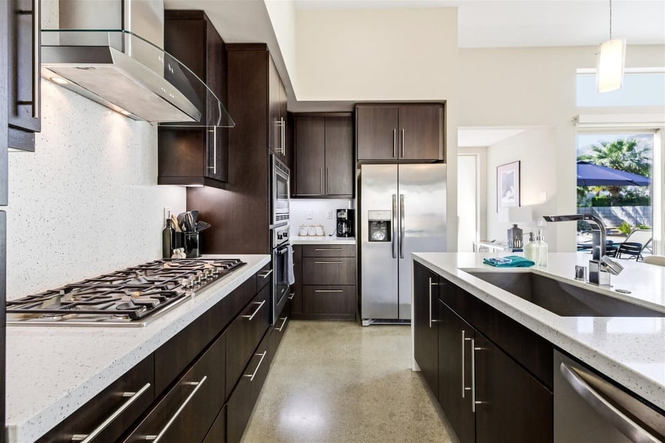 Modern chef's kitchen with quartz counters & stainless appliances