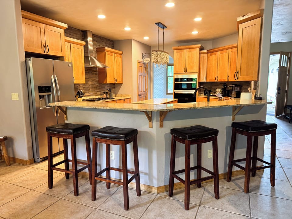 Well appointed chef's kitchen with storage, bar seating, coffee station and more