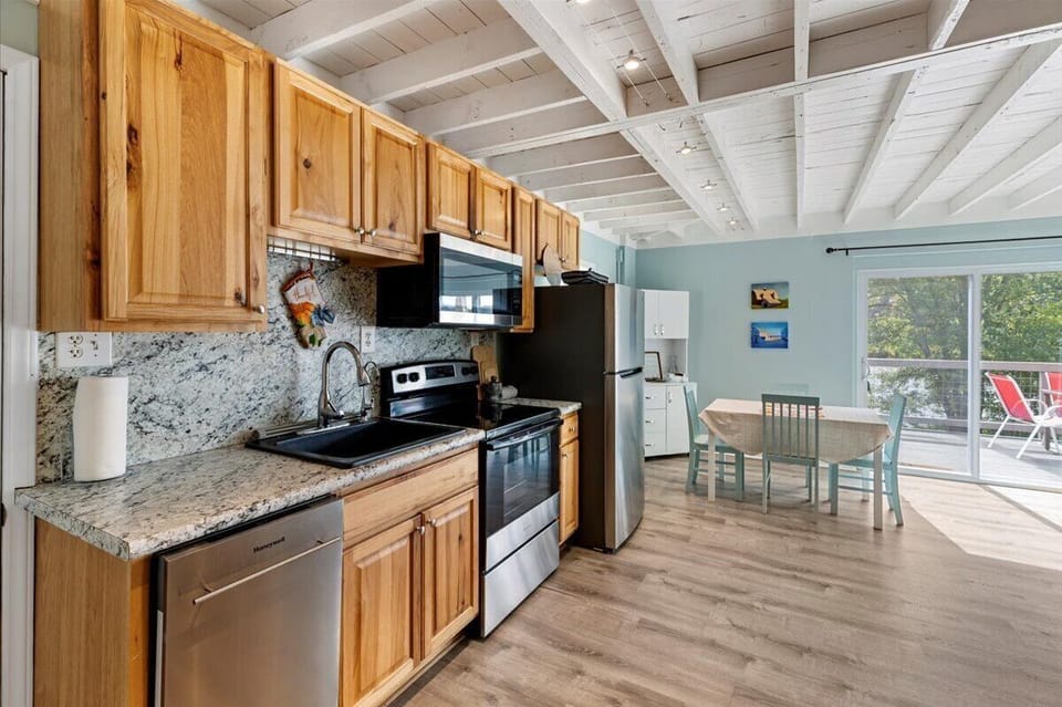 Galley kitchen, full size refridgerator, stove and microwave.  Seating for 4
