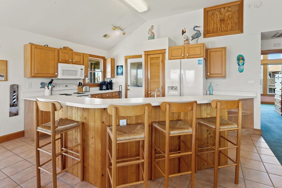 The fully-equipped Kitchen offers panoramic sound views that make even meal prep feel like part of the vacation.