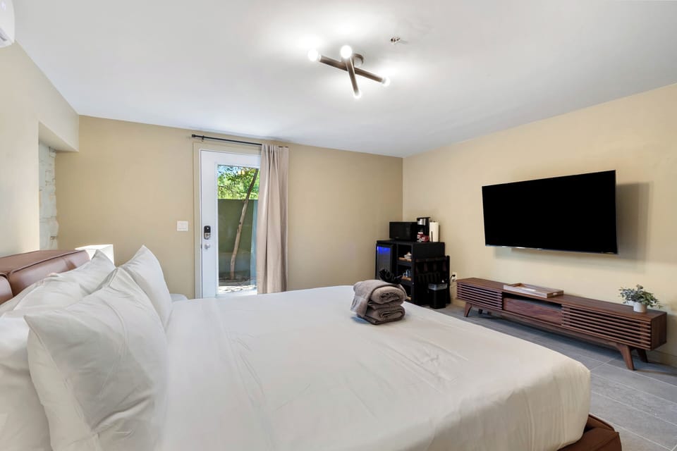 The spacious suite includes a King bed, Smart TV, one plush chair for sitting, microwave, coffee maker and ADA compliant bathroom.