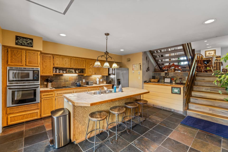 Down a level is the large kitchen space with barstools for additional entertaining space.