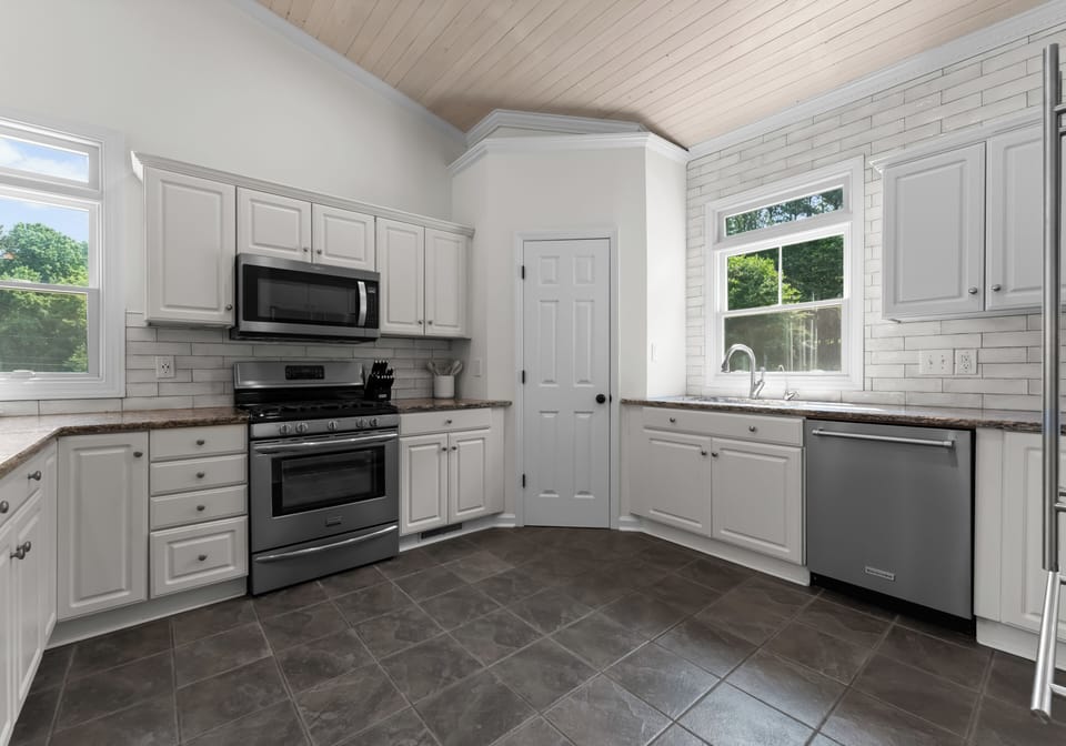 Modern kitchen with stainless appliances and sleek cabinetry.