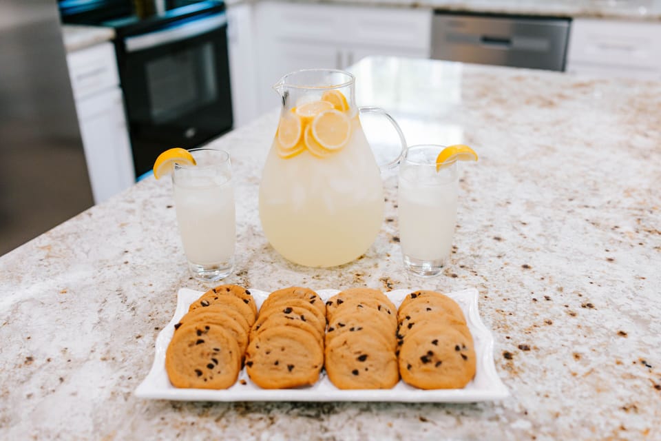 Bright kitchen island with fresh lemonade and homemade cookies