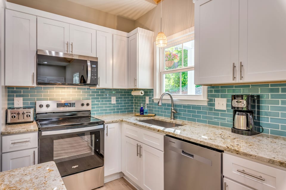 Bright modern kitchen with granite counters and stainless appliances