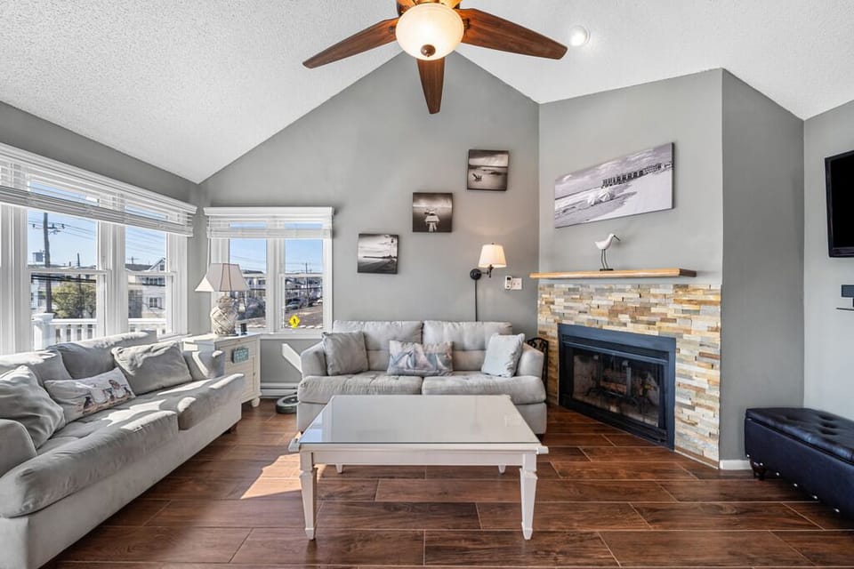 Warm living room with charming fireplace and sunlit windows.