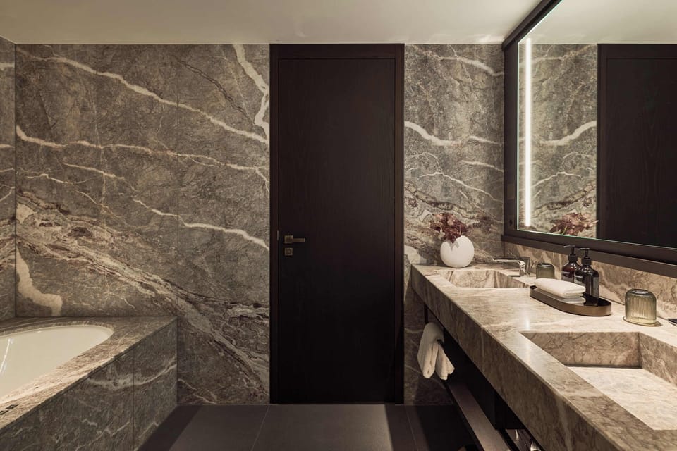Corner Suite | Bathroom | Designer toiletries, hair dryer, bathrobes, slippers