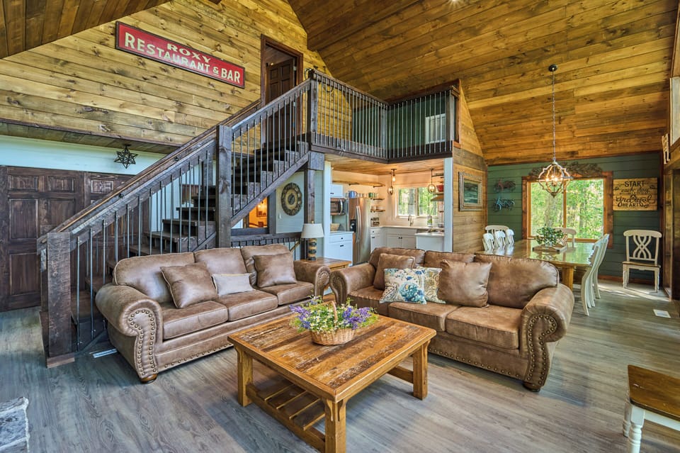 Relax in this rustic-style cabin with seating, vaulted wood ceilings, and a charming dining area.