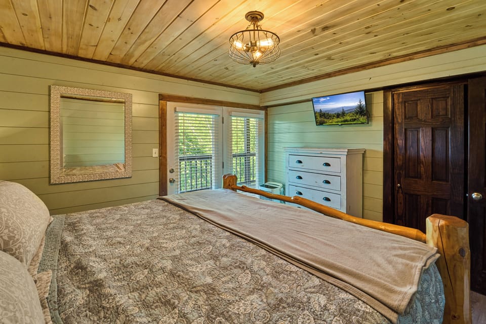 Elegant Bedroom Retreat: Relax in a stylish room with wooden accents and mountain views!