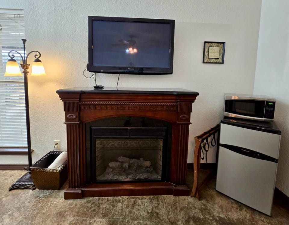 Living Room Retreat: Enjoy a charming space with a TV, electric fireplace, and refreshments at hand!