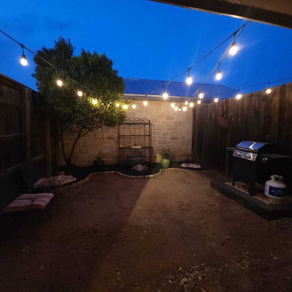 Backyard Oasis: Enjoy starry nights under twinkling lights and grill your favorites in style!