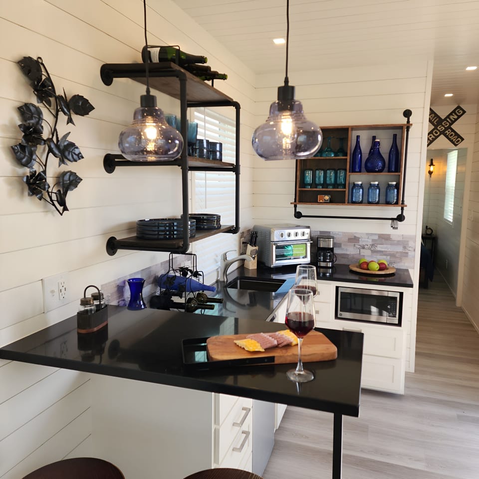 Kitchenette Oasis: Stylish setup with sleek finishes and delightful wine-ready ambiance!