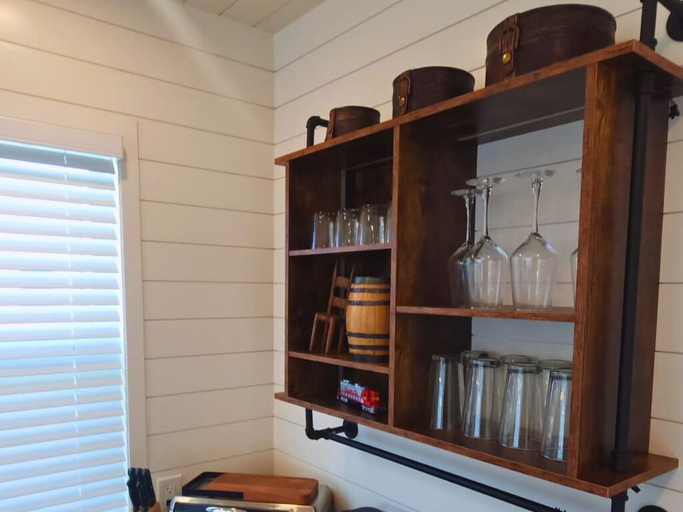 Rustic shelving with elegant glassware and vintage accents awaits your culinary adventures!