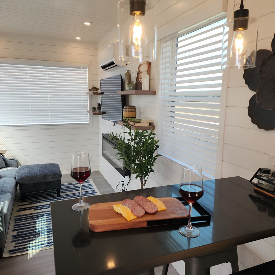 Living Room: Modern design meets charm—enjoy wine, cheese, and great views in style!