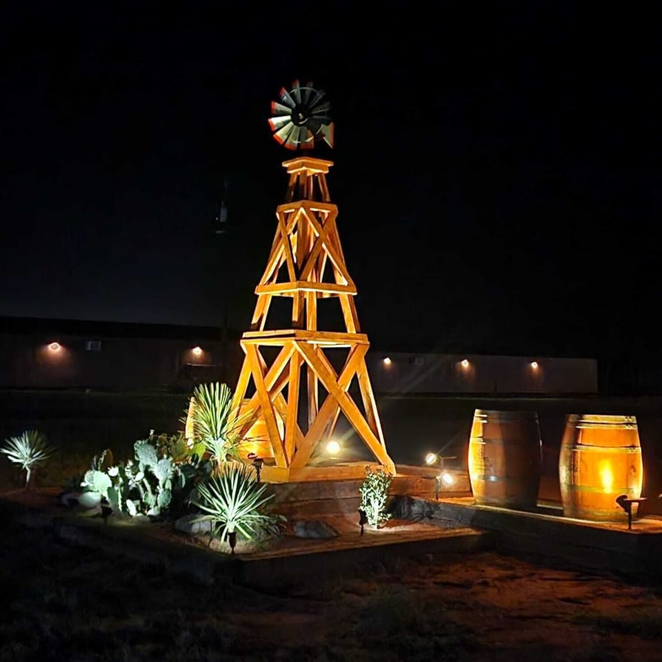 Outdoor Oasis: Charming wooden windmill and vibrant cacti welcome you under the stars!