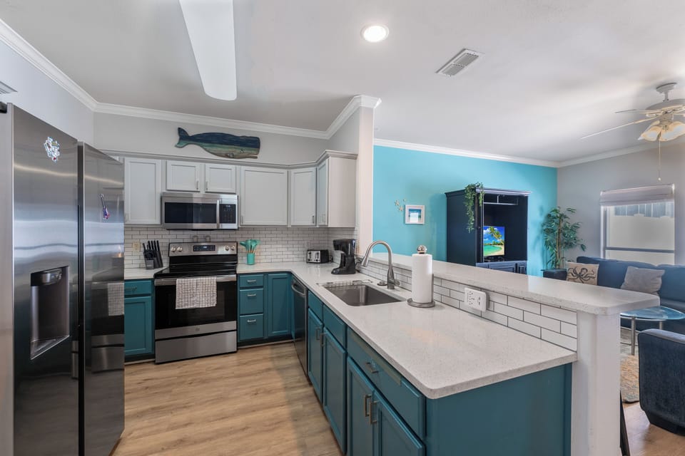 Your bright, fully-equipped kitchen awaits with modern appliances and coastal charm for memorable meal prep.