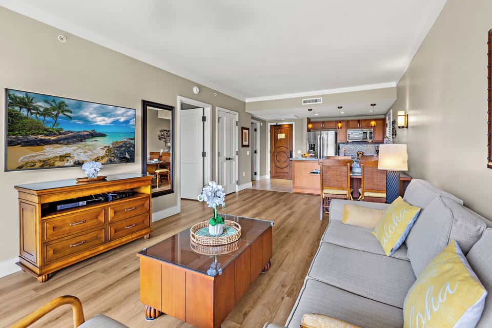 Unwind in your bright, open living space with comfortable seating, modern amenities, and tropical artwork setting the perfect vacation mood.