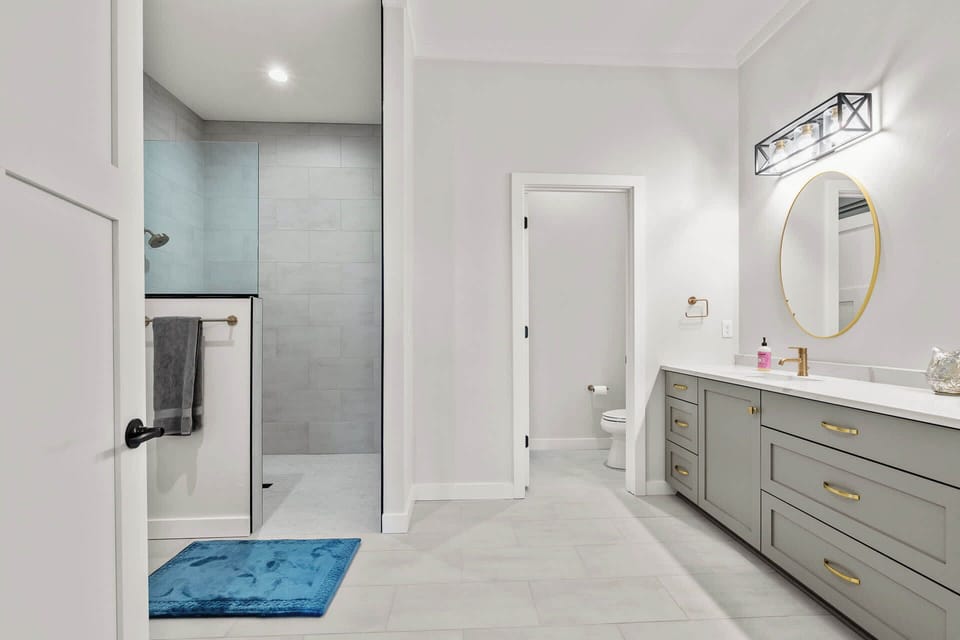 Ensuite bathroom with dual vanity, water closet and soaker tub