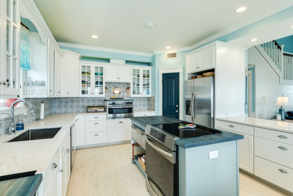 Kitchen features induction range, warming drawer, filtration for water