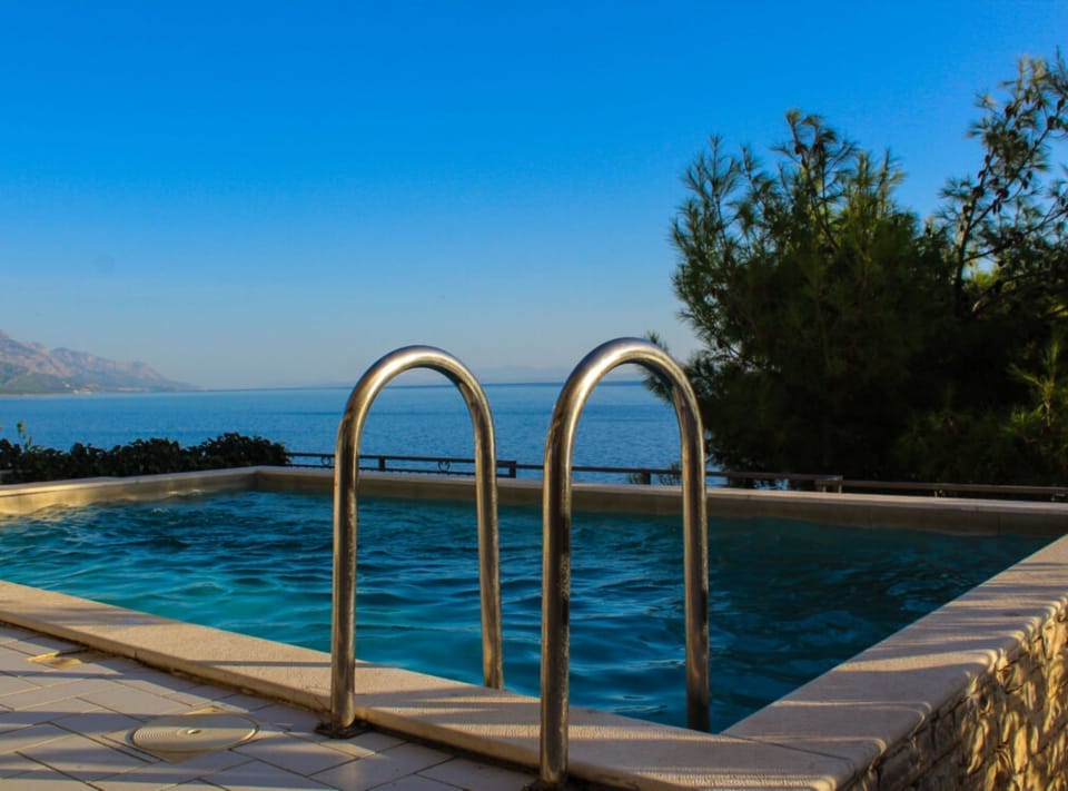 Apartment (Two Bedroom Apartment with Sea View a) | Pool | Seasonal outdoor pool, pool umbrellas, sun loungers