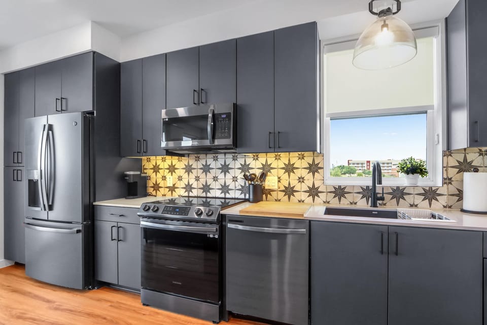 The sleek, open kitchen offers ample space & every home comfort