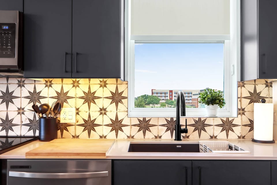 The sleek, open kitchen offers ample space & every home comfort
