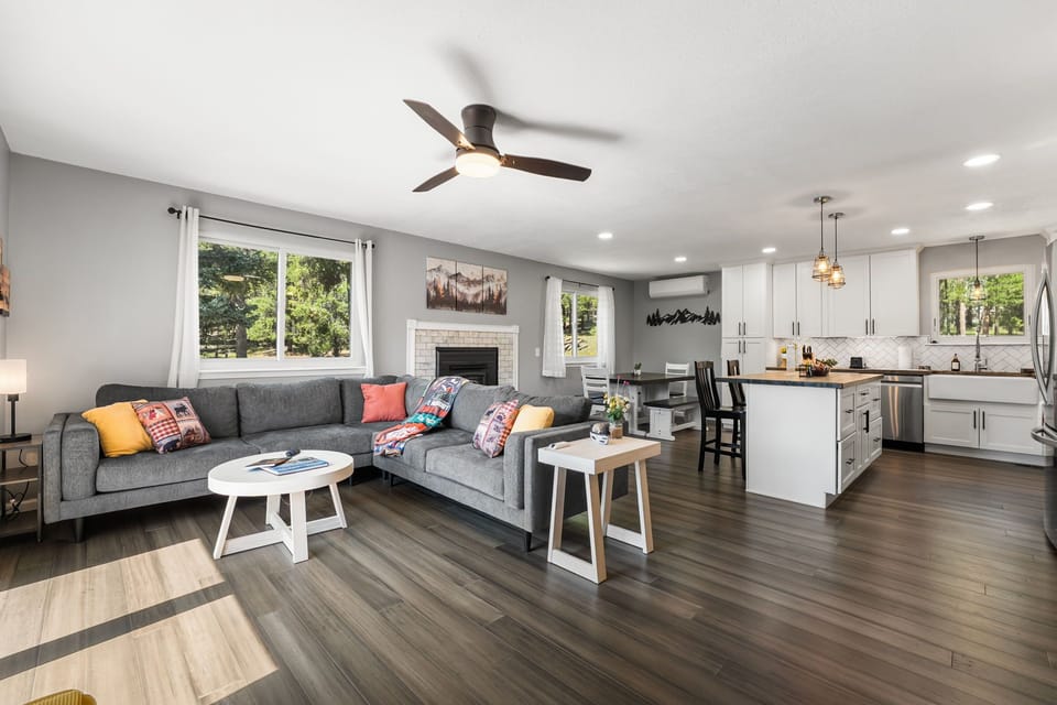 Relax in the open concept living room. 65" smart TV, fireplace, ceiling fan, AC