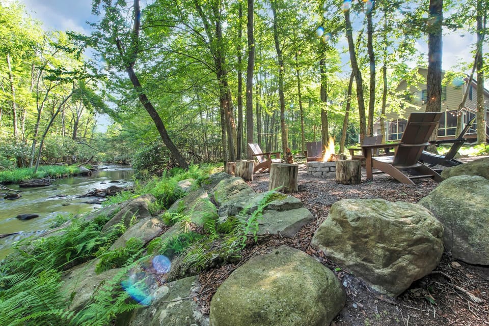 This secluded picnic table in the woods is the perfect spot for good food, great company, and a splash of nature magic.